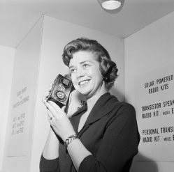 Woman Listening to Solar-powered Radio Donna Johnson listens to a solar-cell-powered transistor radio at a Hobby Industry Association of America show in Chicago. A flick of the switch changes the radio operation from solar power to pen light batteries. February 5, 1963. February 5, 1963 Chicago, Illinois, USA